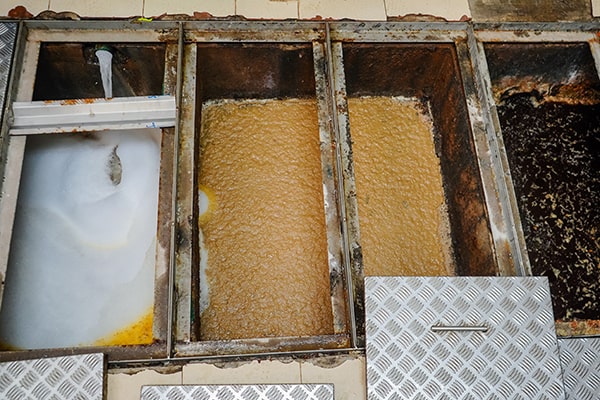 foul odors and slow draining sinks are signs that a grease trap maintenance is needed